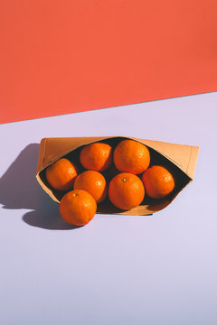 Oranges in a Container on Red and Blue Background