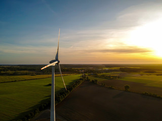 Wind turbine at sunset. Energy from wind.