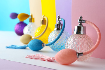 Composition with different bottles of perfume on color background, closeup