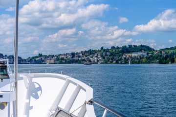 View of Swiss vilage or lakeshore from boat near Lucerne, Switzerland