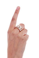 Womans hand is holding up one finger over white background