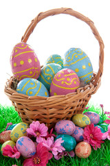 Basket full with colorful easter eggs over white background