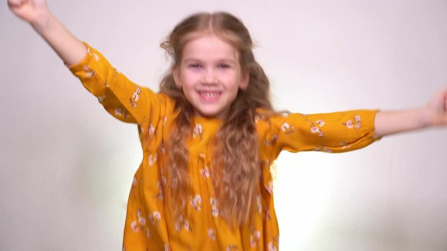 rejoices and Leaps in the girl in the orange dress