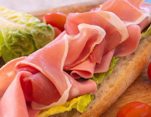Tasty and healthy sandwich with ham and cheese and herbs
