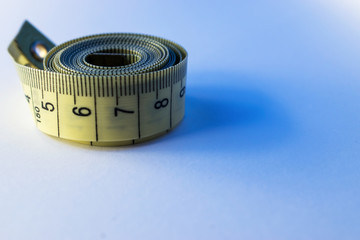 Measuring tape for sewing is on the table. Background for sewing.