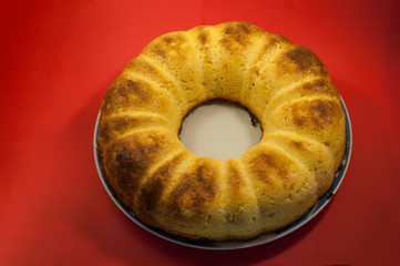 Tasty homemade cheesecake on red table. Selective focus