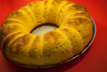 Tasty homemade cheesecake on red table. Selective focus