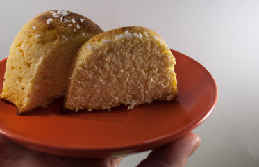 homemade cheesecake serving on red plate on palm