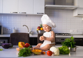  little boy, white chef hat, vegetables