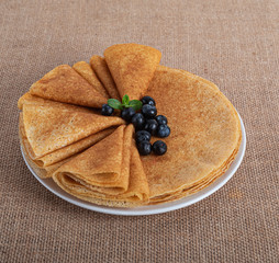 pancakes with berries and on a wooden Board