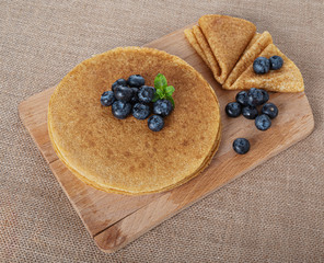 pancakes with berries and on a wooden Board