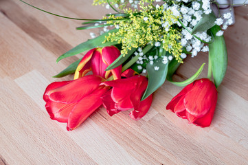 Beatiful spring tulips bouquet on rustic wooden table backhround, space for text
