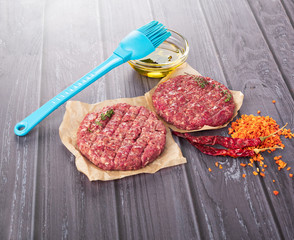 Burger cutlet on craft paper with pepper and spices
