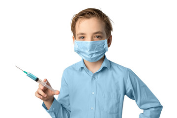 A Caucasian boy wearing a gauze mask on his face to protect against infection holds a syringe with medication in his hand. White isolated background, copyspace