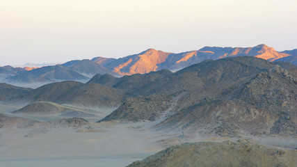 Sunrise on hills in desert