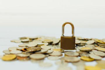 Coin money and lock, on gray background. Saving and financial security concept.