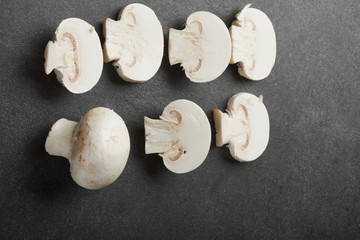 Fresh champignon mushrooms on wooden table, closeup. Space for text