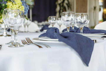 wedding table decor with blue tablecloth and glasses in restaurant