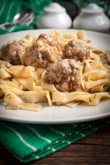 Tagliatelle pasta with beef meatballs.