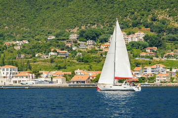 Sunny view of yacht in the Bay of Kotor near the town of Herceg Novi, Montenegro.