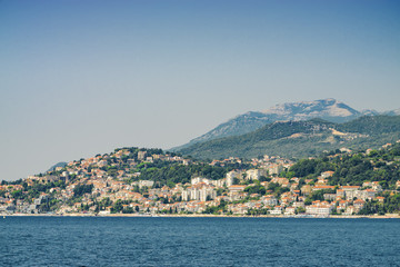 Fototapeta na wymiar Sunny view of the Herceg Novi from the sea on the background of mountains, Montenegro.