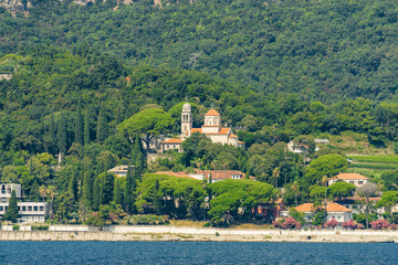 Fototapeta premium Sunny view of the Herceg Novi from the sea on the background of mountains, Montenegro.