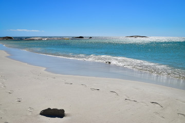 Fototapeta na wymiar White sand and blue ocean at Camps Bay Beach, Cape Town, South Africa