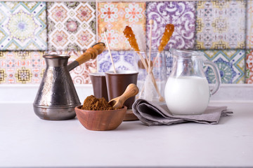 Freshly ground coffee with several ingredients for make coffee over home kitchen