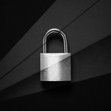Minimal black texture background with padlock for data protection