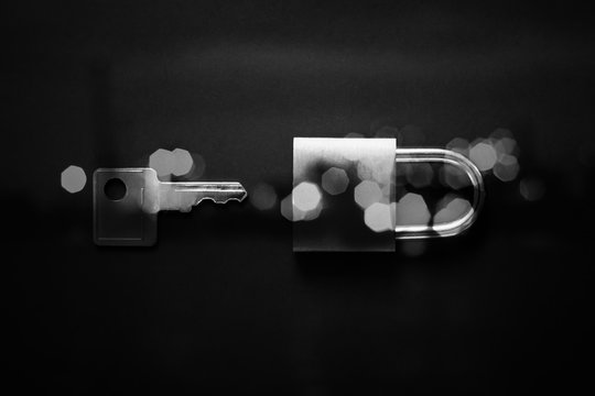 Minimal black texture background with key and padlock