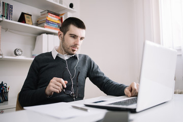 Guy with headphones taking an online course
