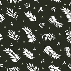 Seamless graphic pattern with the image of white palm leaves on a black background. Vector illustration