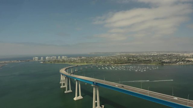 Wide aerial, San Diego Bay bridge leads to Coronado Island