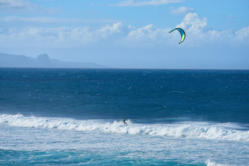 Panoramic view of the ocean with kite surfer on a windy day on Maui island in Hawaii.