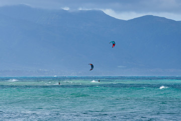 Panoramic view of the ocean with kite surfer on a windy day on Maui island in Hawaii.