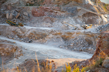 Deep and extensive outdoor excavation in a stone quarry exploited outdoors. Urban planning, primary...
