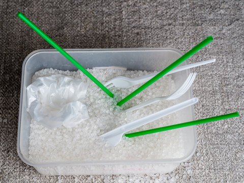 plastic utensils and straws for cocktail in granules of plastic. Polypropylene