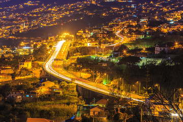 Aerial view of highway at night crossing the famous Funchal capital in Madeira island