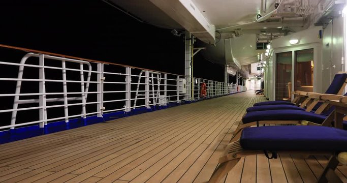 Cruise ship outdoors deck chairs night. Luxury all inclusive vacation travel in style. Passengers enjoy international destinations aboard large ocean vessels. Recreation, shows, food, dancing and fun.
