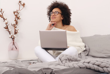 Woman thinking, thoughtful happy female working on laptop portrait. Looking for inspiration concept