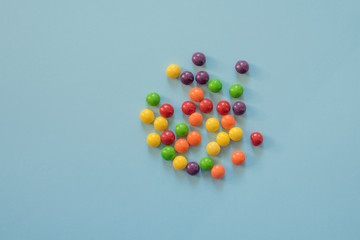 colored round sweets on a blue background