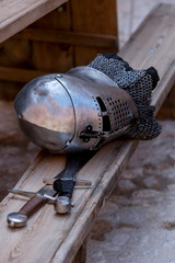 Close-up of a medieval helmet, gloves and sword