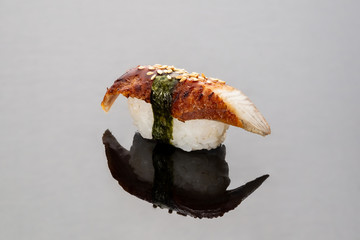 Eel sushi on a mirror background