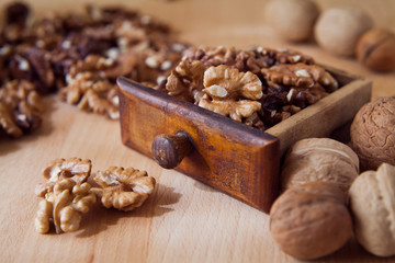Fresh healthy walnuts nuts seeds on the wooden rustic board. Close up of the the open halves.