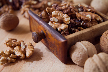 Fresh healthy walnuts nuts seeds on the wooden rustic board. Close up of the the open halves.