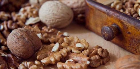 Fresh healthy walnuts nuts seeds on the wooden rustic board. Close up of the the open halves.