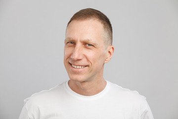 middle-aged man headshot in a white t-shirt