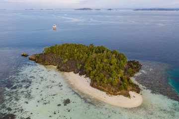 Healthy coral reefs fringe remote limestone islands amid Raja Ampat, Indonesia. This amazing region...