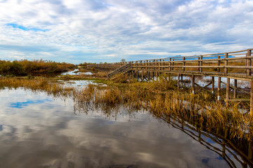 Nature wooden boardwalk in Lake Vistonida, Porto Lagos, Xanthi regional unit, Greece on a sunny winter day
