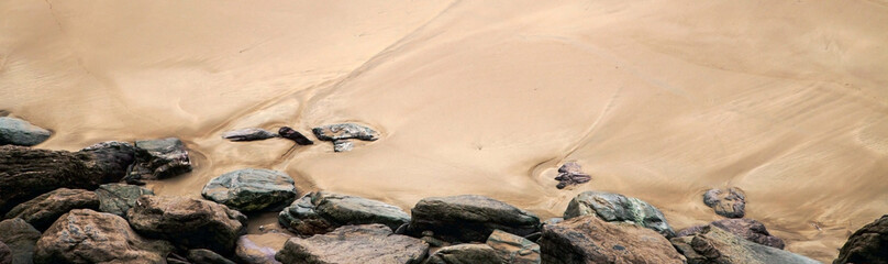 Beach, rocks & sand in panorama / header / banner - for design, and concepts of nature or natural landscape.